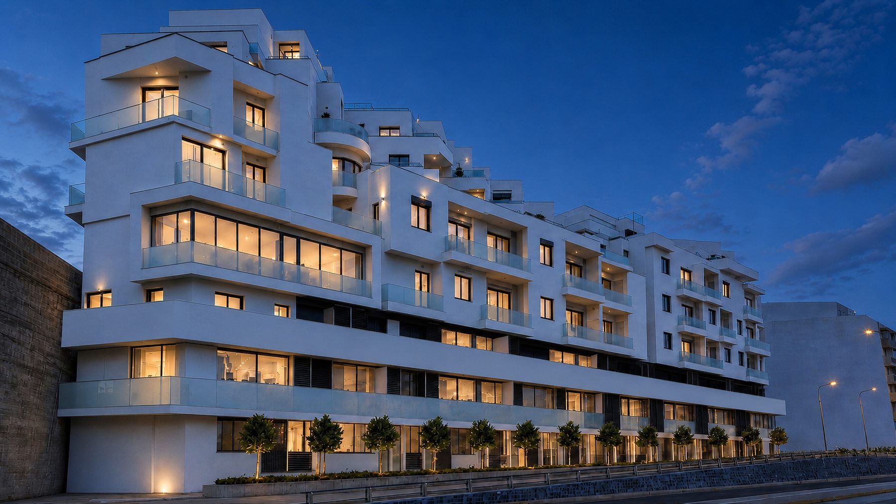 Residential development at dusk with every apartment lit