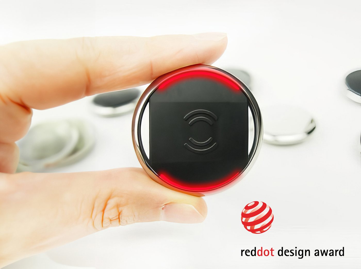 Biisafe Buddy button, a Red Dot design award winner, held in the hand
