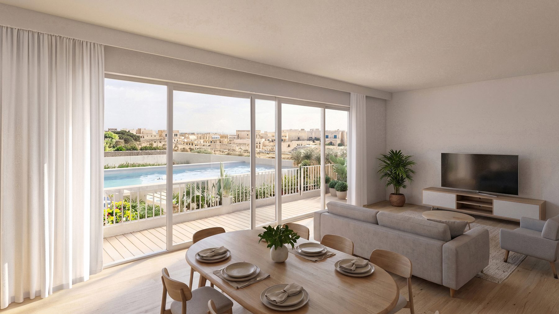 Apartment living and dining space opening onto a terrace, pool and village beyond