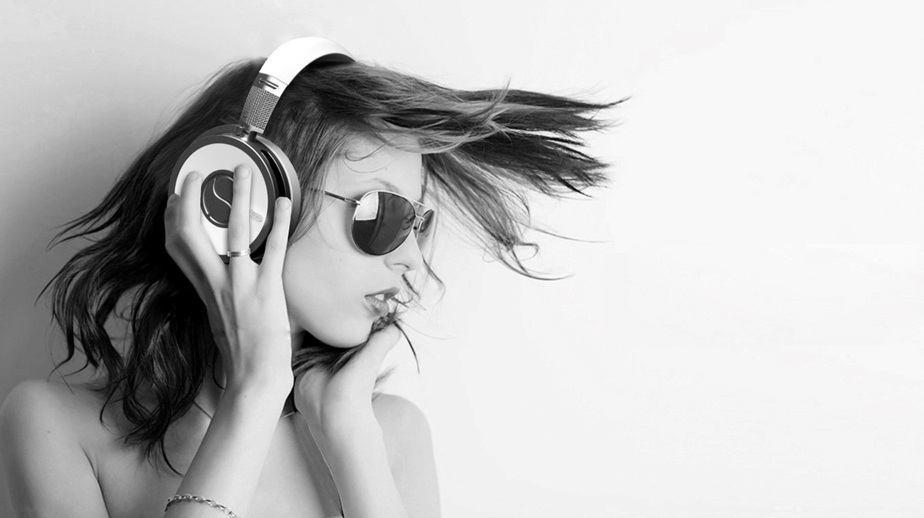 Black and white lifestyle image of headphones worn by a model