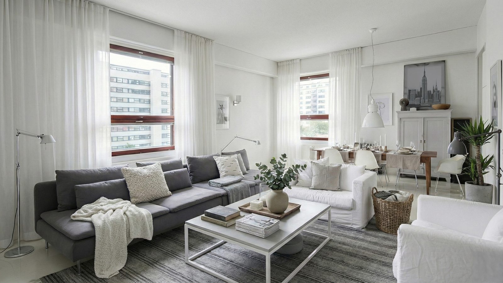 The same room staged in a pale Nordic style with a dining setting